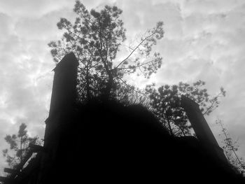 Low angle view of building against cloudy sky