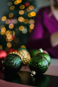 Midsection of woman preparing baubles on table