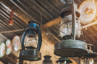 Low angle view of old lanterns hanging from ceiling