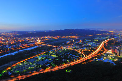 Illuminated cityscape against sky at night