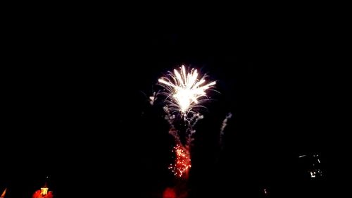 Low angle view of firework display at night