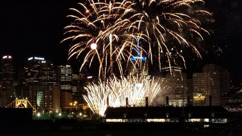 Firework display in city at night