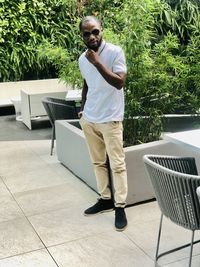 Full length of young man standing against plants