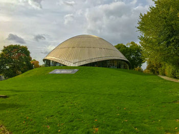 Built structure on field in park against sky