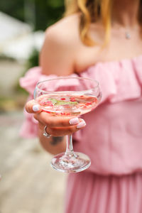 Midsection of woman holding drink