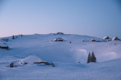 Scenic view of snowcapped mountains against clear sky