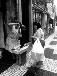 Woman standing on sidewalk