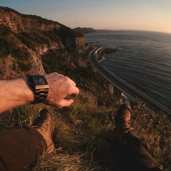 Low section of man by sea on cliff