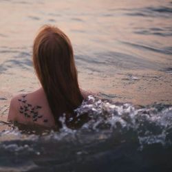 Rear view of woman at beach
