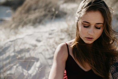 Beautiful young woman looking down