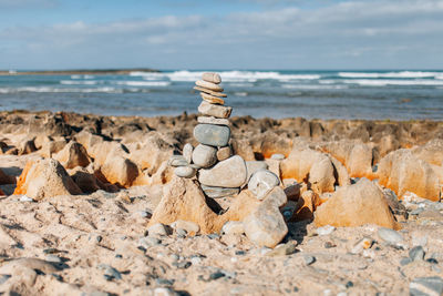 Close-up of rocks on beach against sky