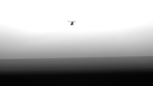 Low angle view of airplane flying against clear sky