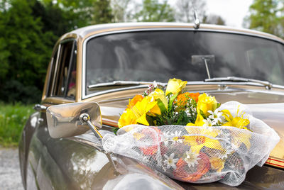 Vintage wedding car decorated with flowers