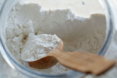 Directly above shot flour with wooden spoon in jar