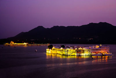 Scenic view of illuminated mountains against clear sky at night