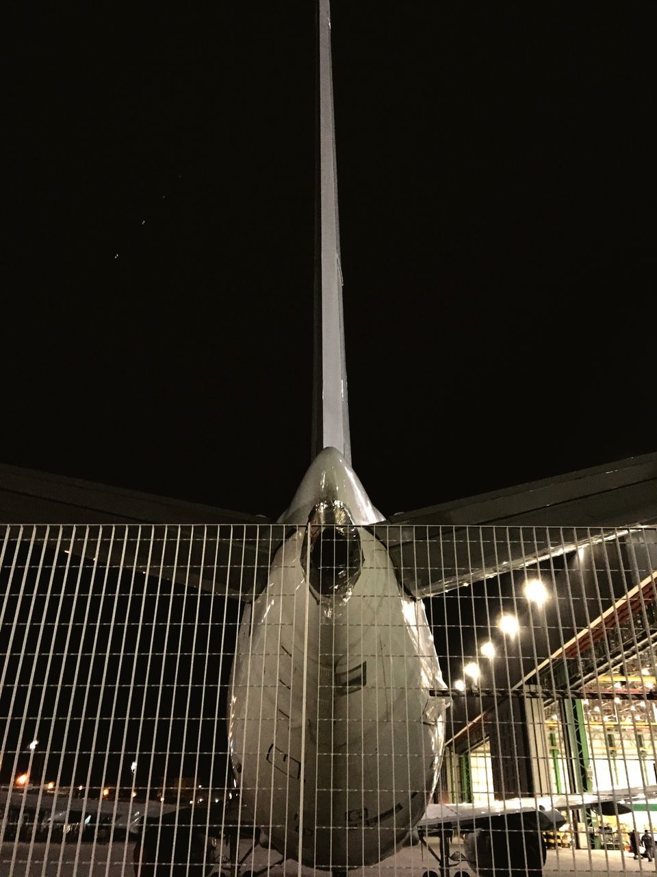 night, illuminated, built structure, architecture, low angle view, building exterior, metal, lighting equipment, clear sky, copy space, no people, modern, pattern, outdoors, sky, city, metallic, reflection, arts culture and entertainment, hanging