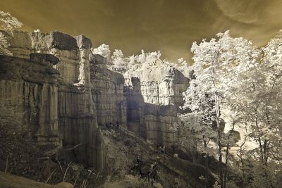 Panoramic view of buildings and rock formation against sky