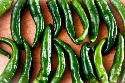 Full frame shot of green chili peppers on table