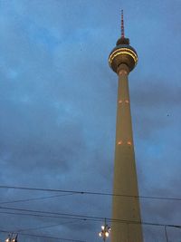 Low angle view of communications tower against sky