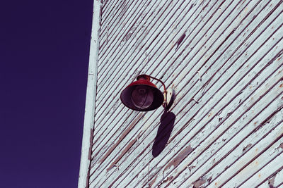 Low angle view of electric lamp on building