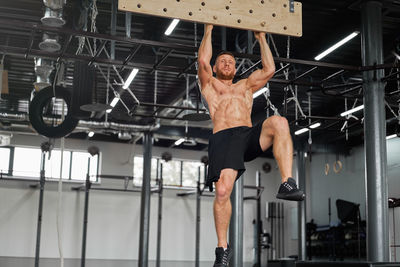 Low angle view of man with arms outstretched