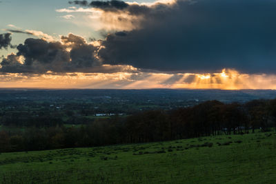 Scenic view of field against sky during sunset