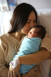 Close-up of mother with baby sleeping