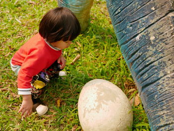 High angle view of girl sitting on field