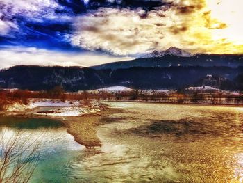 Scenic view of mountains against cloudy sky