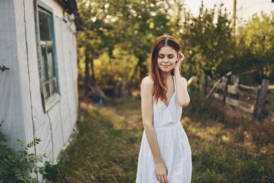 Portrait of smiling young woman standing outdoors