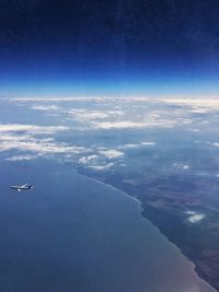 Aerial view of airplane wing over sea