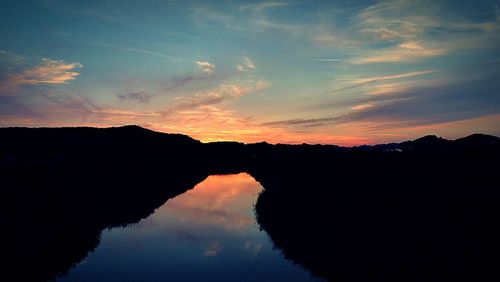 Scenic view of silhouette mountains against sky during sunset