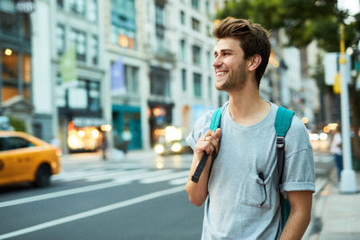 Young man standing in city