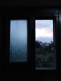 Close-up of glass window against building