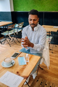 Man sitting on table at cafe