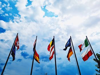 Low angle view of flag flags against sky