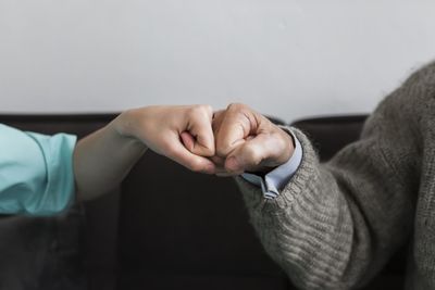 Cropped hand of man and woman doing fist bump