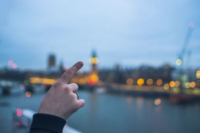 Optical illusion of person touching big ben at dusk