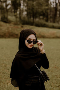 Young woman wearing sunglasses standing outdoors