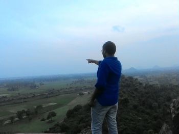 Full length of woman standing on landscape