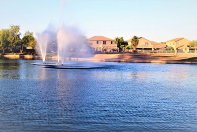 Panoramic view of lake and buildings against clear sky