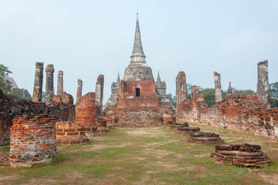 Historic temple against buildings