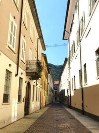 Narrow street amidst buildings against sky