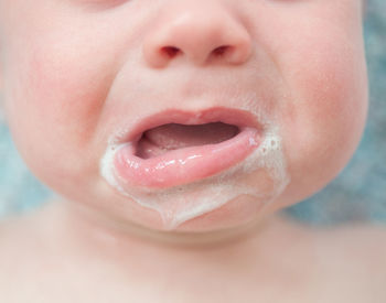 Cropped image of messy baby boy mouth