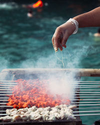 Cropped image of hand holding barbecue grill