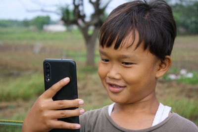 Portrait of boy using mobile phone