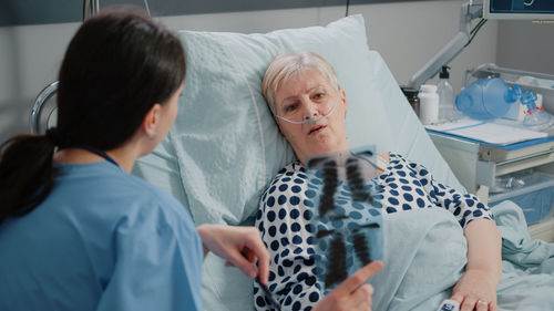 Nurse showing medical xray to patient