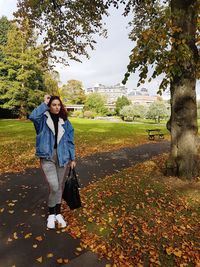 Young woman standing in park during autumn