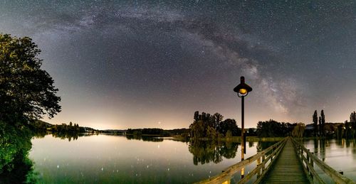 Scenic view of canal against sky at night