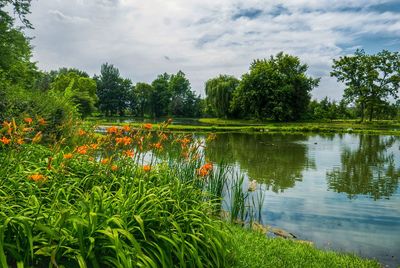 Scenic view of lake against cloudy sky